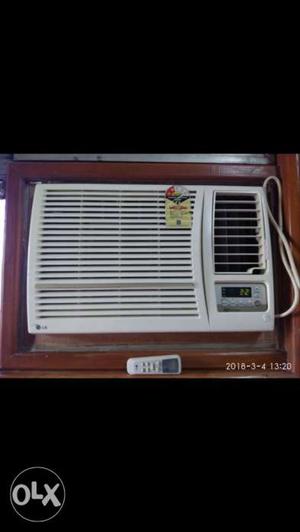 White LG Window-type Air Conditioner With Text Overlay