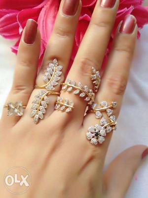 Four Gold-colored White Rhinestone Encrusted Leaf Rings