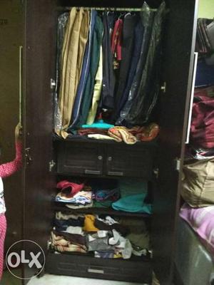 Clothes Lot And Brown Wooden Clothes Cabinet