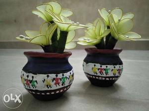 Pot home decors with artificial flowers.