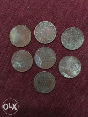Seven Round Copper-colored Indian Anna Coins