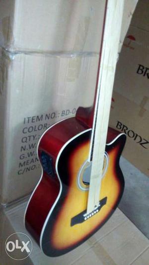 Yellow, Red, And Black Cutaway Acoustic Guitar