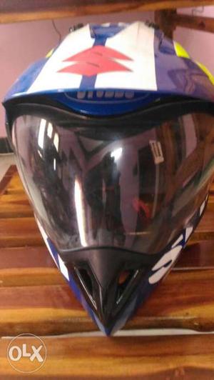 White, Yellow, And Blue Suzuki Motocross Helmet