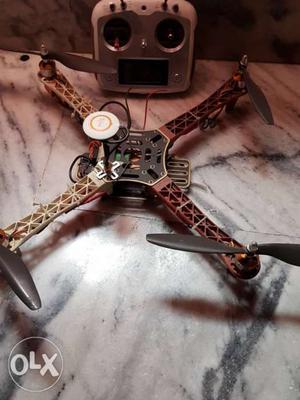 Gray And Brown Quadcopter With Remote Control