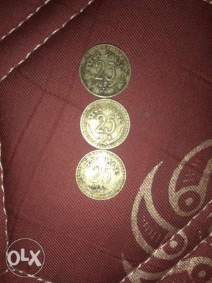 Three Round Gold-colored 25 Paise Coins