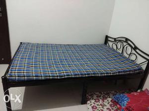 Black Steel Bed Frame And Blue Mattress