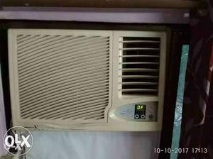 Beige And White GE Window-type Air Conditioner