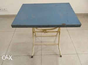 Folding and height adjustable metal table.
