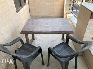 A plastic Dinning Table & 2 chairs of the same