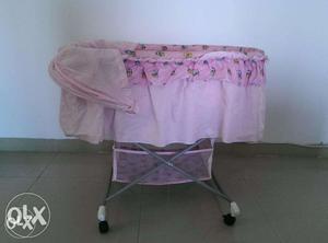 Almost new rocking baby cot/cradle with cover