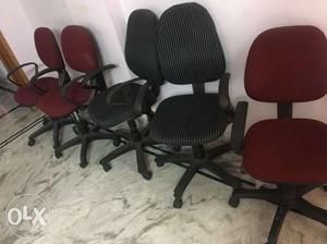 Four Brown Wooden Framed Black Padded Chairs