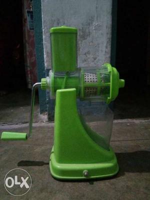 Green coloured hand powered juicer.. Very efficient to be