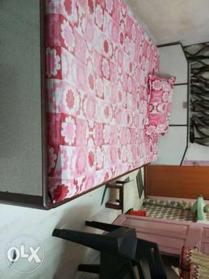White And Pink Floral Bed Sheet With White Wooden Frame