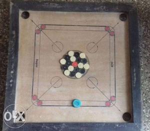 Wooden carrom board with coins