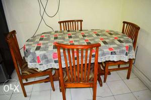 Wooden dining table with 4 chairs under good