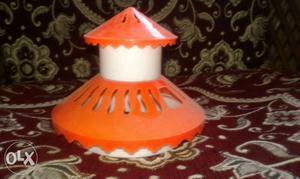 Orange hat for small fish pot along with stones