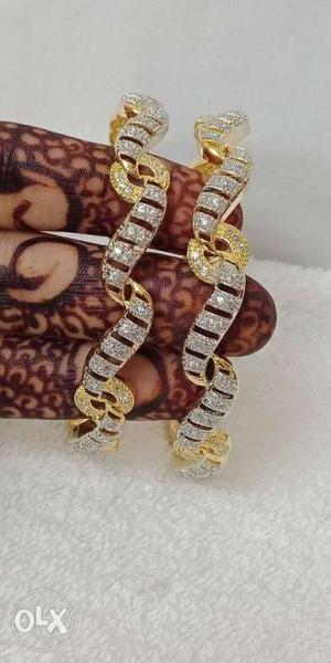 Two Silver-and-gold-colored Bracelets