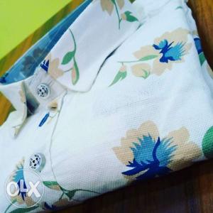 White, Blue, And Green Floral Textile