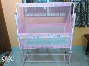 Brand new pink cradle with mosquito net