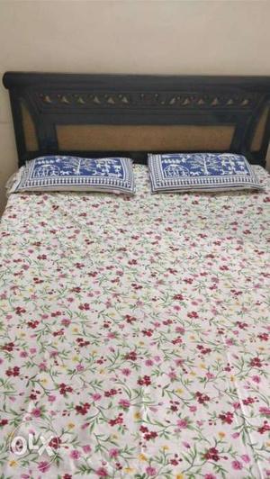 Brown Wooden Bed With Floral Mattress