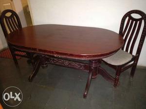 Oval shape dining table in teak, carved stand,