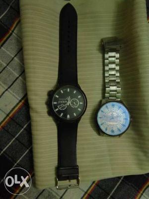 Two Round Silver Chronograph Watches With Black Link