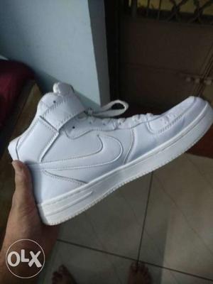 paired White Nike Air Force High-top Shoe