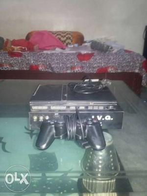 1 year old ps2 and one remote. it has 20 games