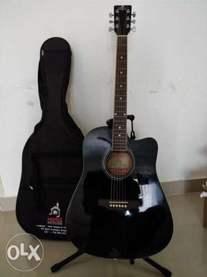 Black Acoustic Guitar And Black Stand