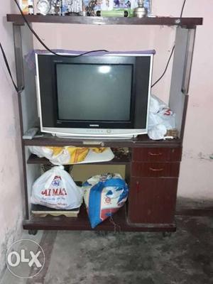 Black CRT TV With Brown Wooden TV Stand