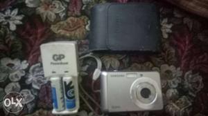 Gray Samsung Point-and-shoot Camera And White Battery