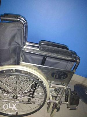 Grey folding wheel chair.in mint condition