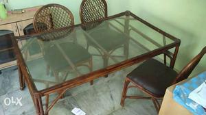 6 year old Cane wood dining table with 4 chairs,
