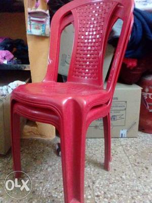 Two Red Monobloc Chairs