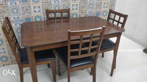Walnut wood four seater dining table with