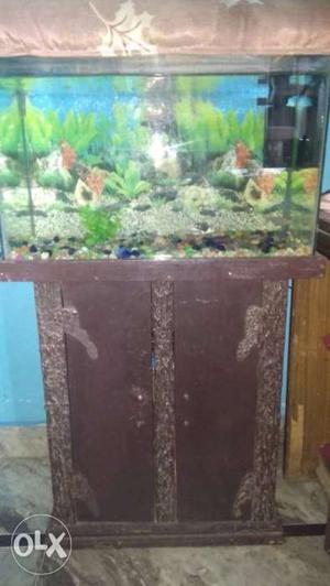 Fish Tank With Brown Wooden Cabinet Stand