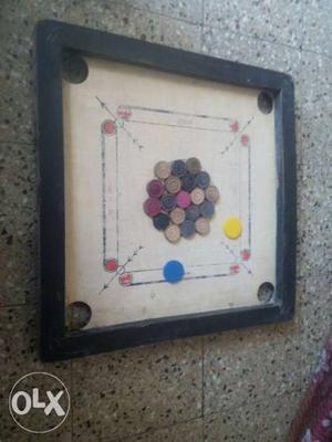 Black And Brown Carrom Board With Carrom Men