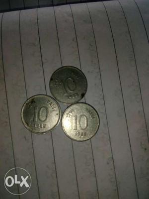 Three Round Silver-colored 10 Indian Paise Coins