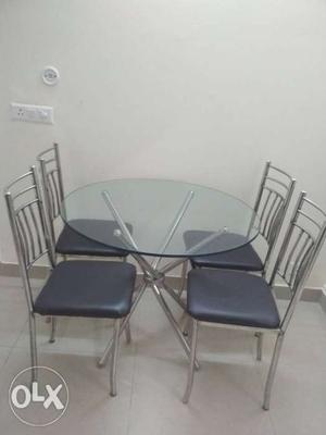 Stainless Steel Framed dining set with 4 Black Leather