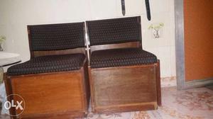 Two Brown Wood-framed Black Fabric Padded Armless Chairs