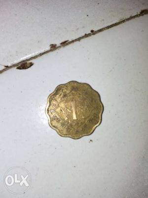 Gold-colored 1 Indian Paise Coin