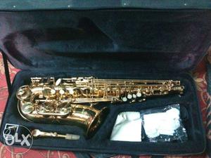 Gold-colored Saxophone With Black Bag