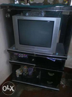 Gray CRT TV With Brown Wooden TV Hutch