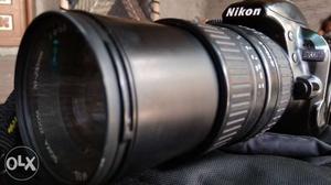 Nikon  mm lens with betry chargher bag