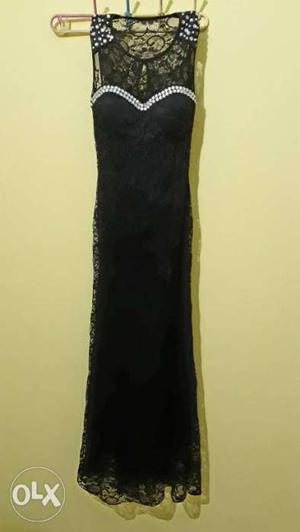 Black long gown with diamond design on shoulder.