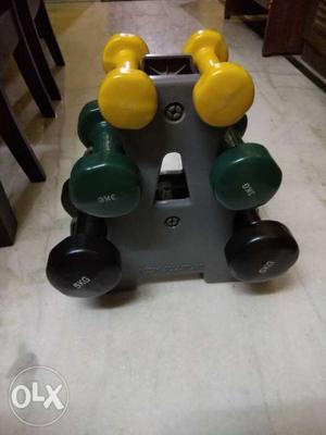 Three Pairs Of Yellow, Green, And Black Dumbbells