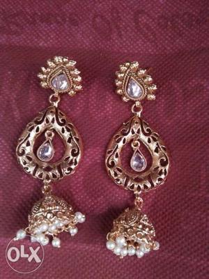 Two Gold-colored Earrings With Clear Gemstones