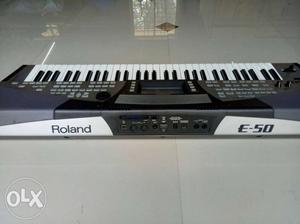 Grey And White Roland E-50 Electronic Keyboard
