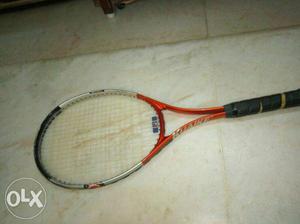 Orange, White, And Black Tennis Racket