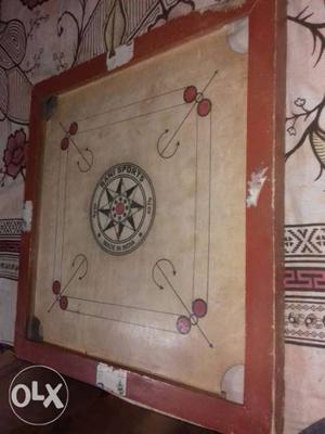 Red And White Wooden Carrom Board